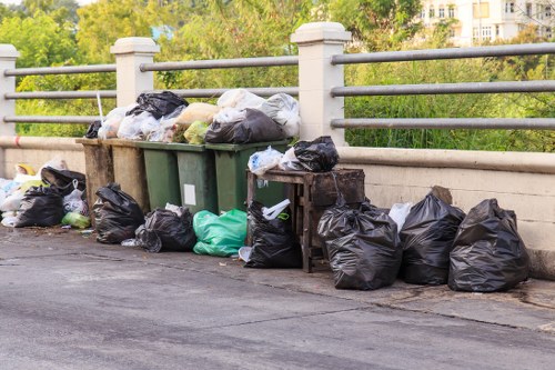 Construction site with builders managing waste clearance